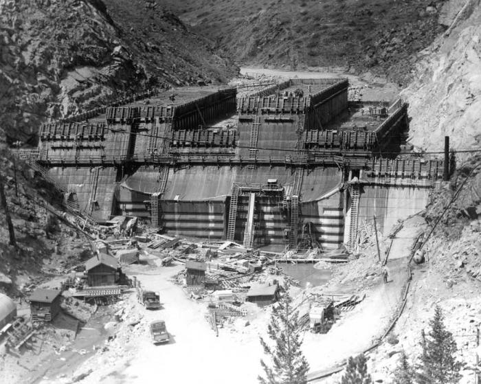 Historic black and white photo of dam construction.