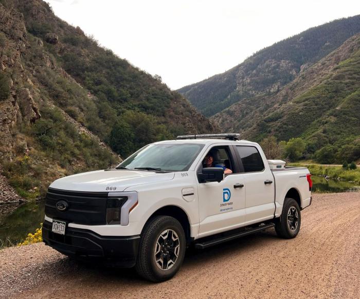 A white truck stops in a canyon