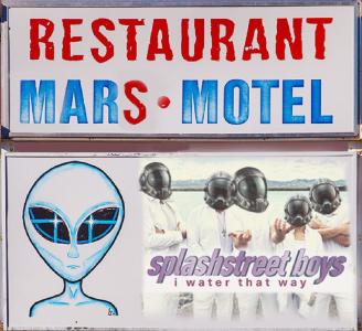 Fictional sign for a Mars restaurant and motel that features a cartoon alien.