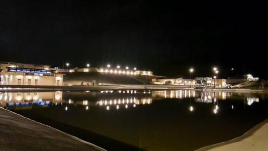 Large building with lights on inside at night