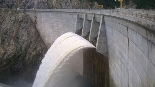 Water spills through a dam's outlet structure