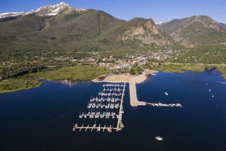 A marina filled with boats in Dillon Reservoir under the mountains at Frisco