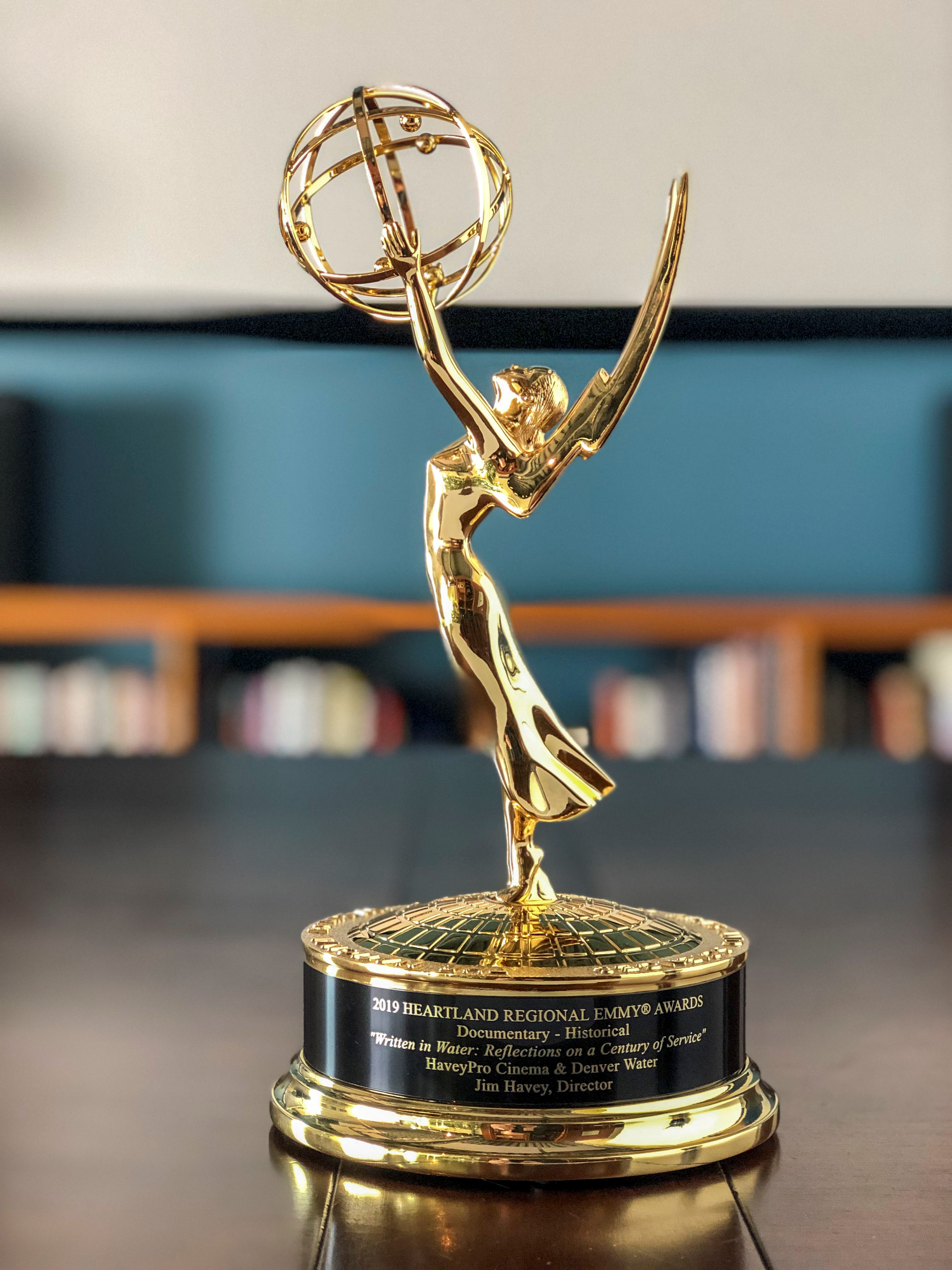 A gold statuette of a woman with wings holding an atom, the symbol of the Emmy award.