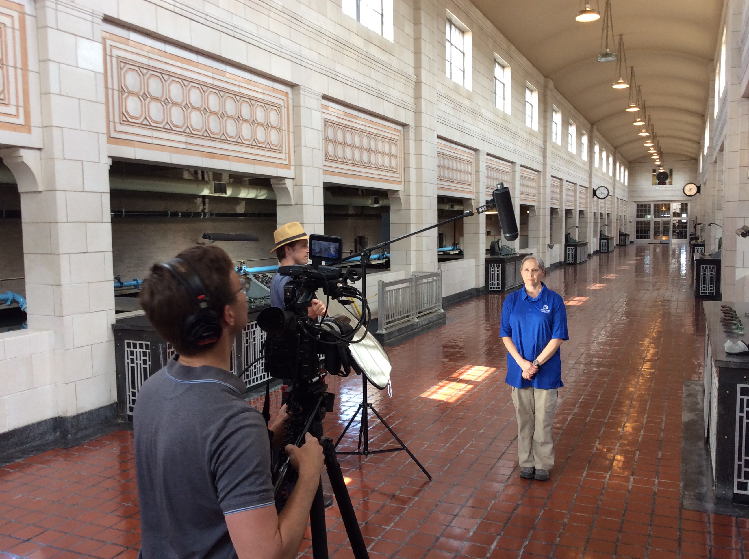 Jean Reding, water treatment lead at Moffat Treatment Plant, does an interview with Nathan Church (left) and Zach Andrews from HaveyPro Cinema in the central hall of the Moffat Treatment Plant for “Written in Water: Reflections on a Century of Service.”