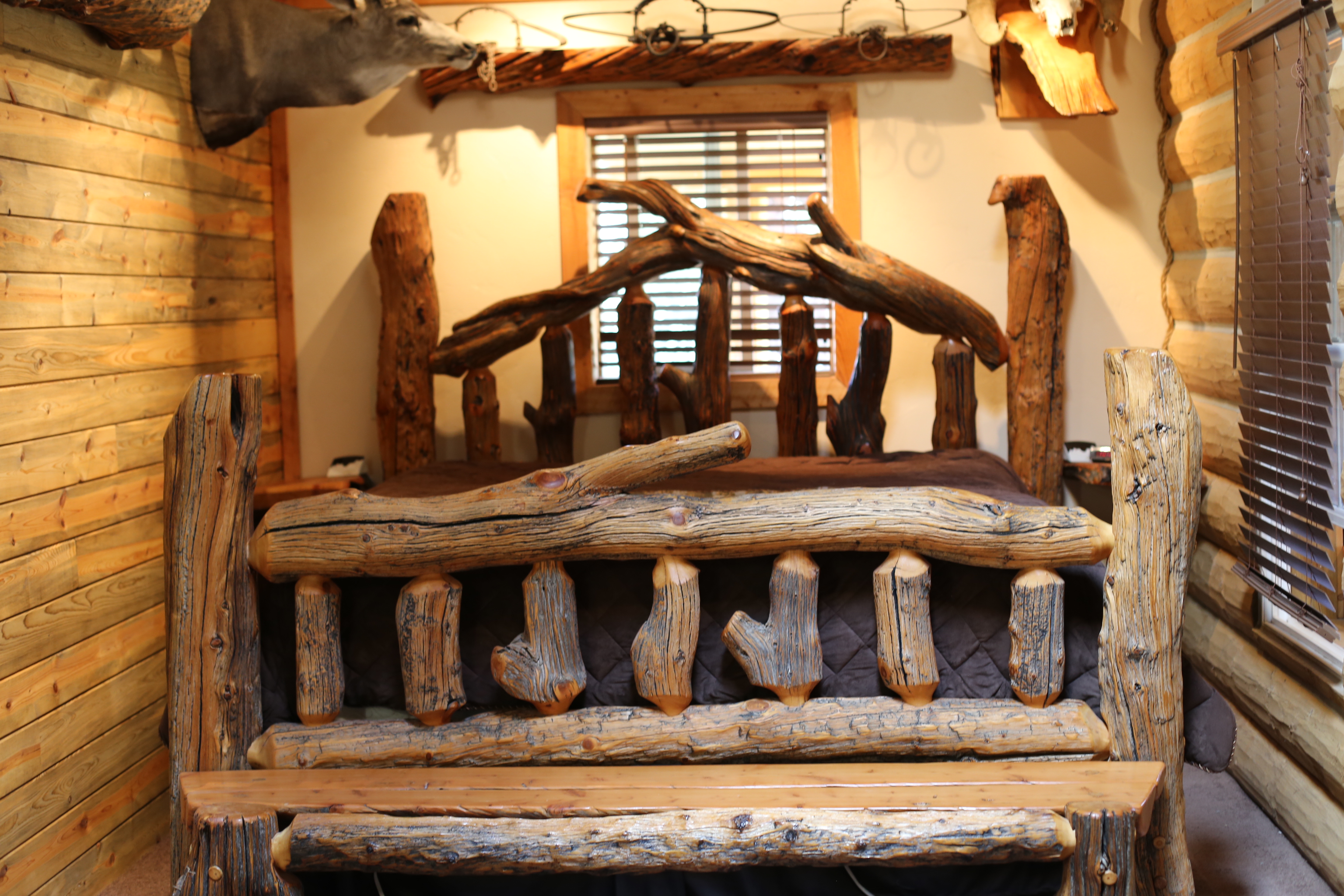 This king-size bed, Hibbs’s first woodworking project, sits in his cabin not far from Antero Reservoir.